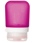 A small 1.7 oz silicone bottle in the color magenta on a white surface. 