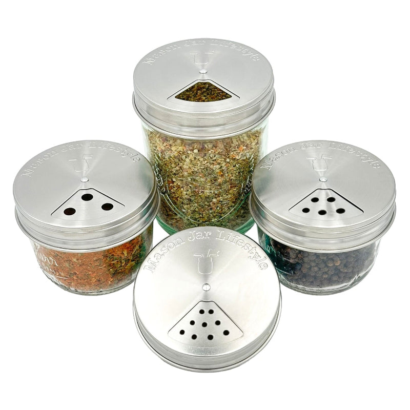 For regular mouth mason jars filled with spices with the stainless steel mason jar spice lids on them. Each one is adjusted to a different opening option showing the large, medium, and small hole options and the pour opening. 