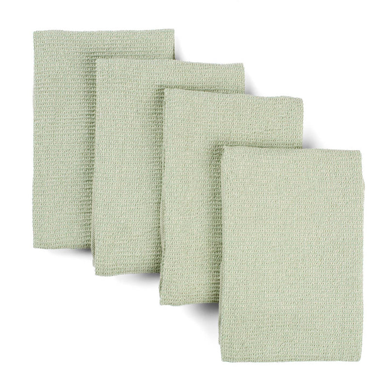 Four sage green waffle weave upcycled cotton towels lying on top of each other on a white background. 