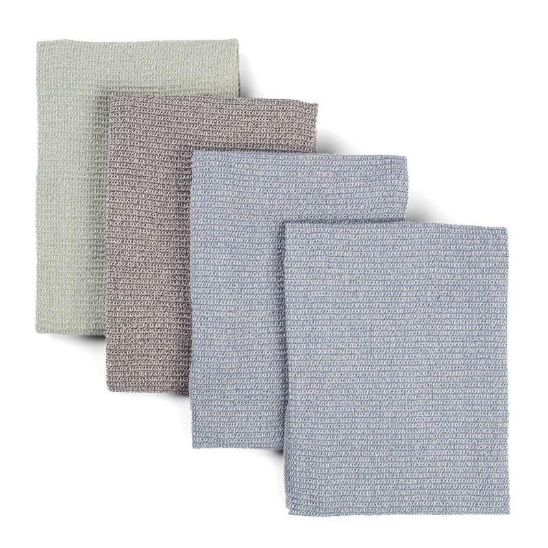 Four waffle weave upcycled cotton towels lying on top of each other on a white background. One towel is sage green, one is grey, and two are light blue. 