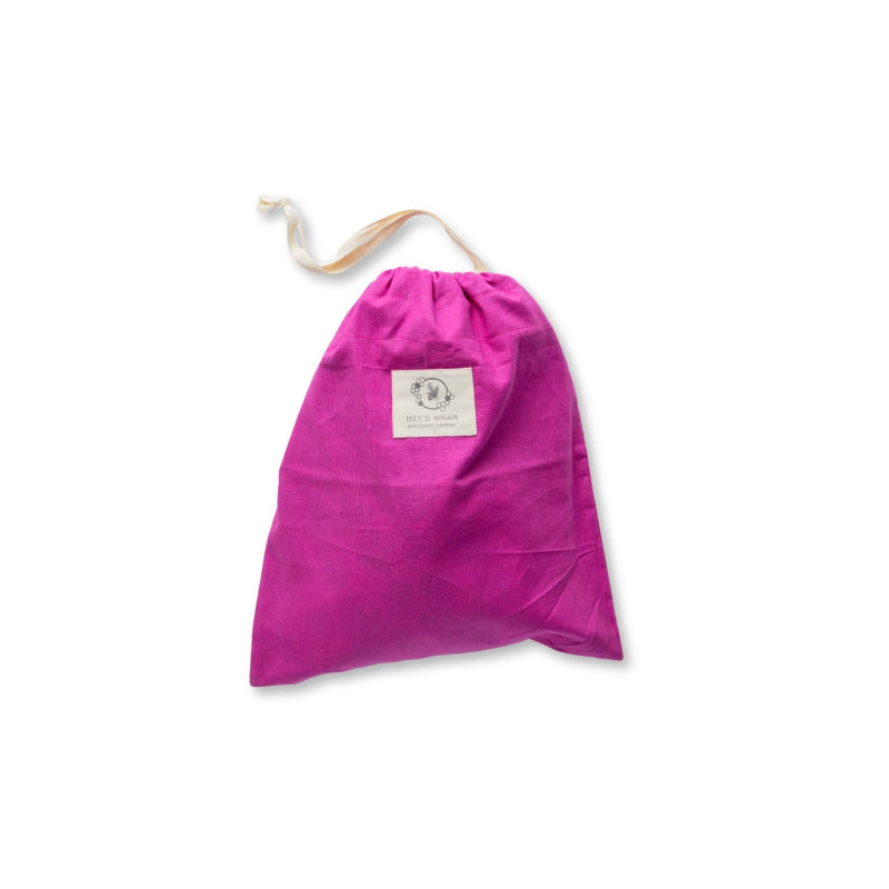 A Magenta Bee's wax lined bread bag with a drawstring top pulled shut on a white background.
