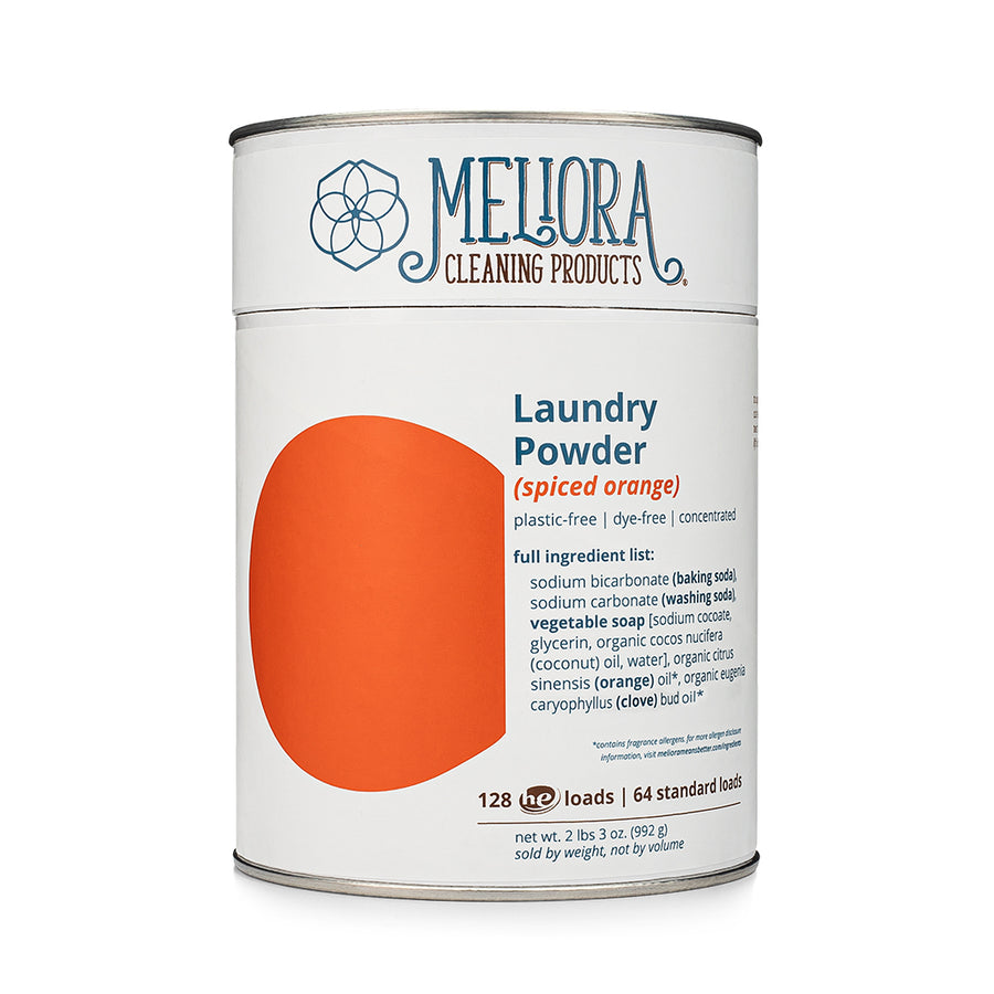 A 2lb cardboard tin of Meliora laundry powder in the scent spiced orange. 