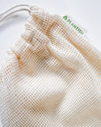 Beige mesh drawstring bag with 'PLANTISH' branding on a light gray background