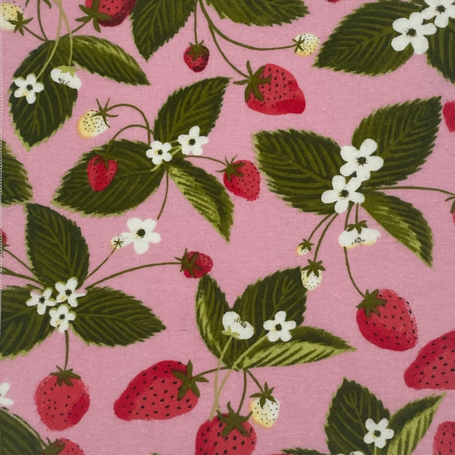 pink fabric with red strawberries, white flowers and green leaf pattern. 