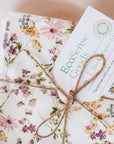 A set of vintage floral no paper towels tied into a bundle with string. 