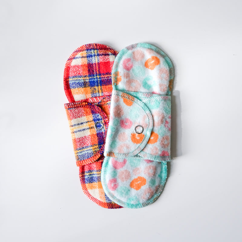 Set of colorful reusable pads on a white background
