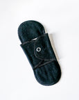 Black reusable menstrual pad on a white background