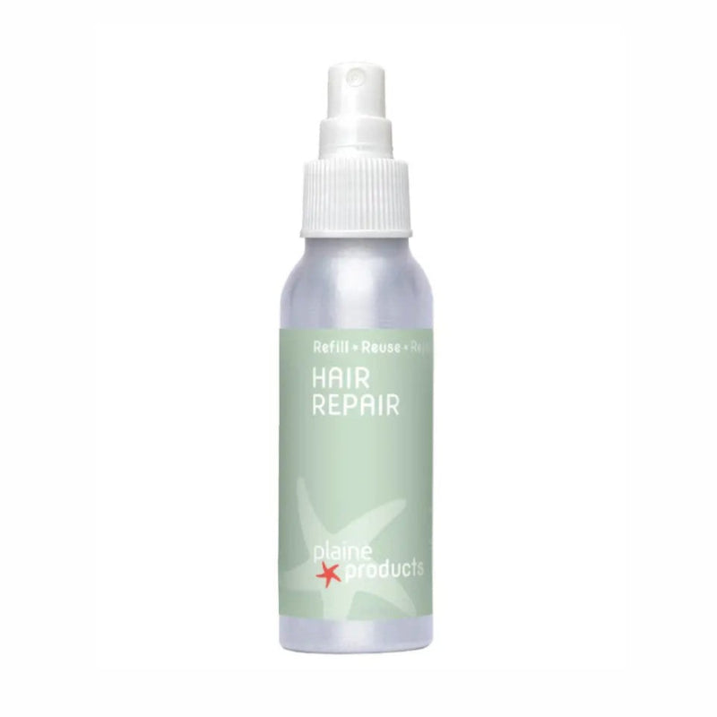 A small metal spray bottle with a green label reading hair repair. 