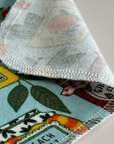 A close up of a corner of the Jars & Jams paperless towel's reverse side and the fuzzy cotton flannel texture. 