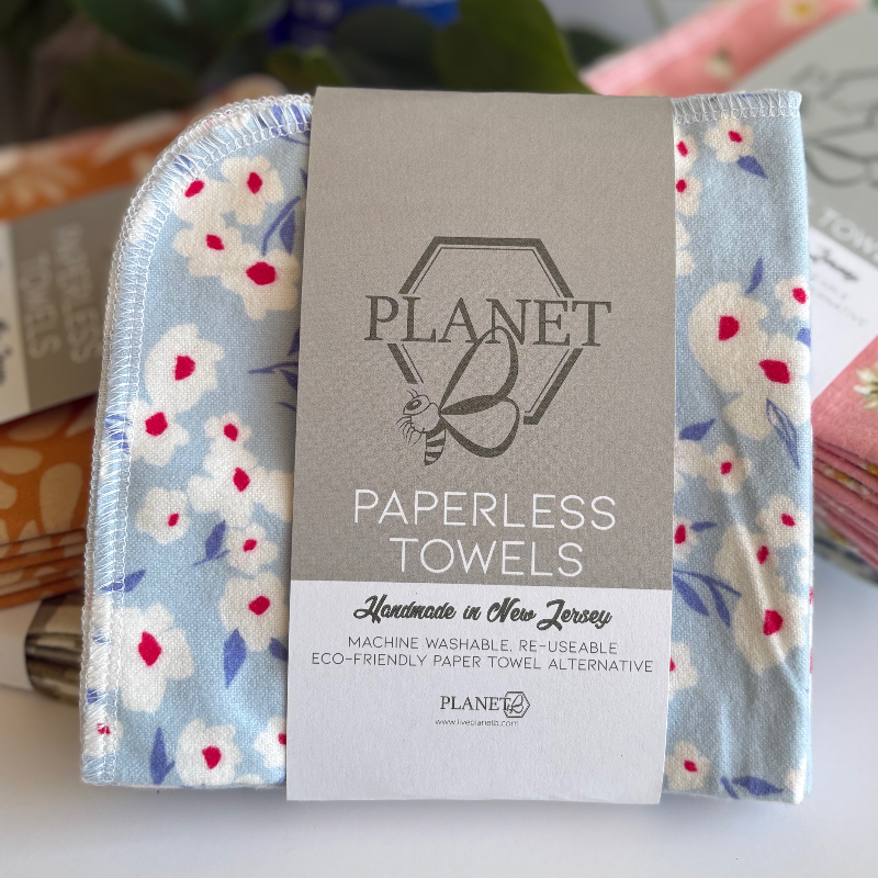 A pack of the Cornflower patterned Paperless towels, featuring white flowers on a blue background.