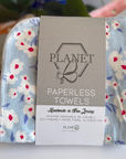 A pack of the Cornflower patterned Paperless towels, featuring white flowers on a blue background.