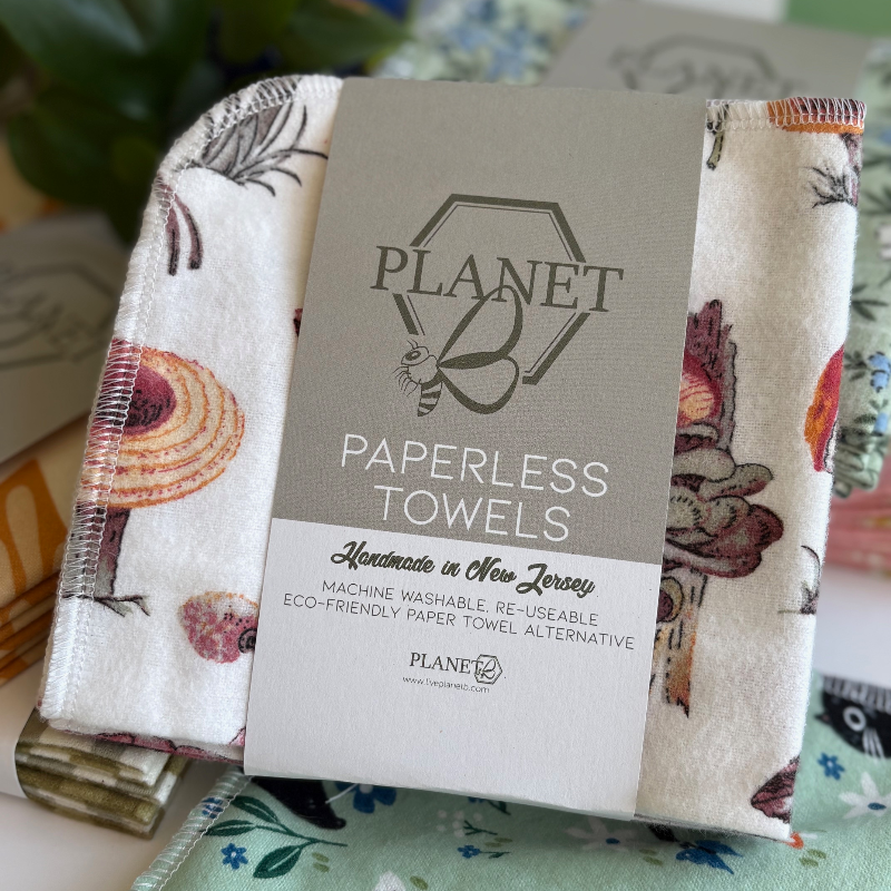 A pack of the Fall Mushrooms patterned paperless towels, featuring orange mushrooms on a cream background. 