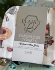 A pack of the Fall Mushrooms patterned paperless towels, featuring orange mushrooms on a cream background. 