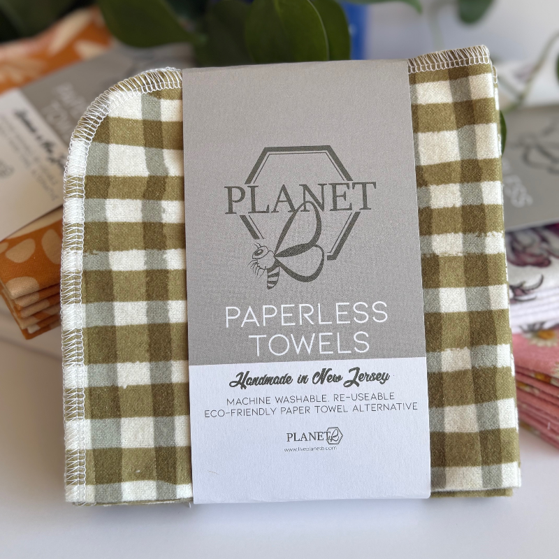 Green gingham patterned paperless towels with Planet B Paperless Towels packaging on a light background