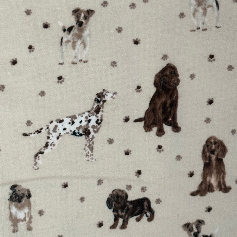 The Puppy Pals patterned Paperless Towel which features dog illustrations and paw prints on a cream background. 