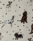 The Puppy Pals patterned Paperless Towel which features dog illustrations and paw prints on a cream background. 
