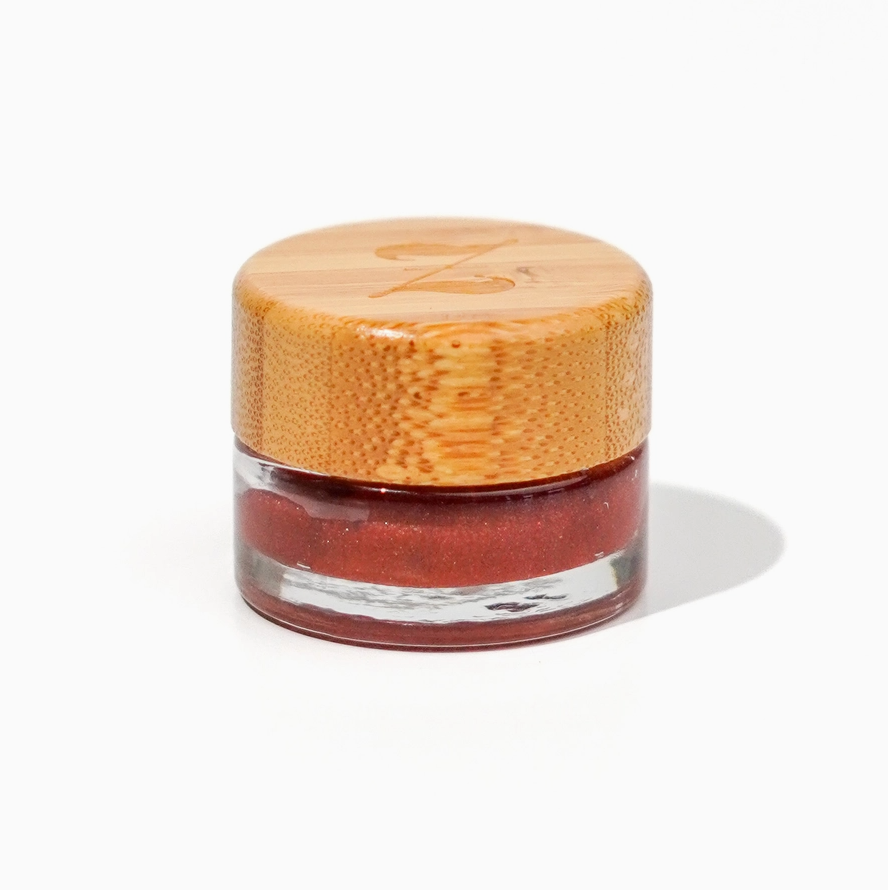 Small jar with a wooden lid on a white background
