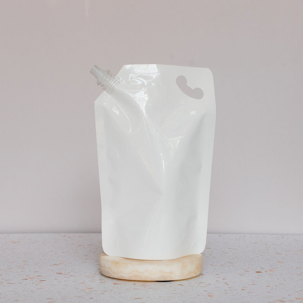 Soft plastic pouch on light pink backdrop. Pouch is designed to be cleaned and reused many times!