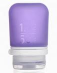 A small 1.7 oz silicone bottle in the color purple on a white surface. 