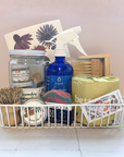 Basket with cleaning and household items on a light background