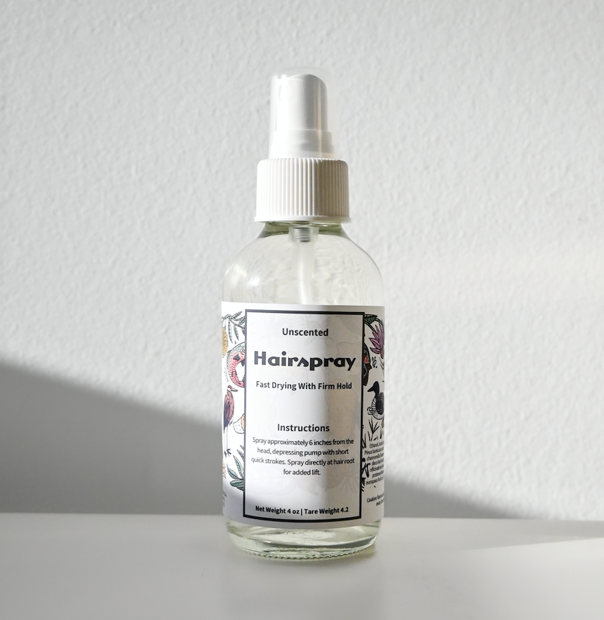 hairspray in refillable mist bottle on white backdrop