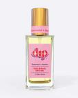 Square glass bottle with gold top and pink label says rosewater jasmine hair and body oil on white background.