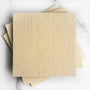 A stack of wool scrubbers on a marble surface. 