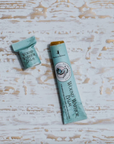 paper tube of wound balm on wood backdrop