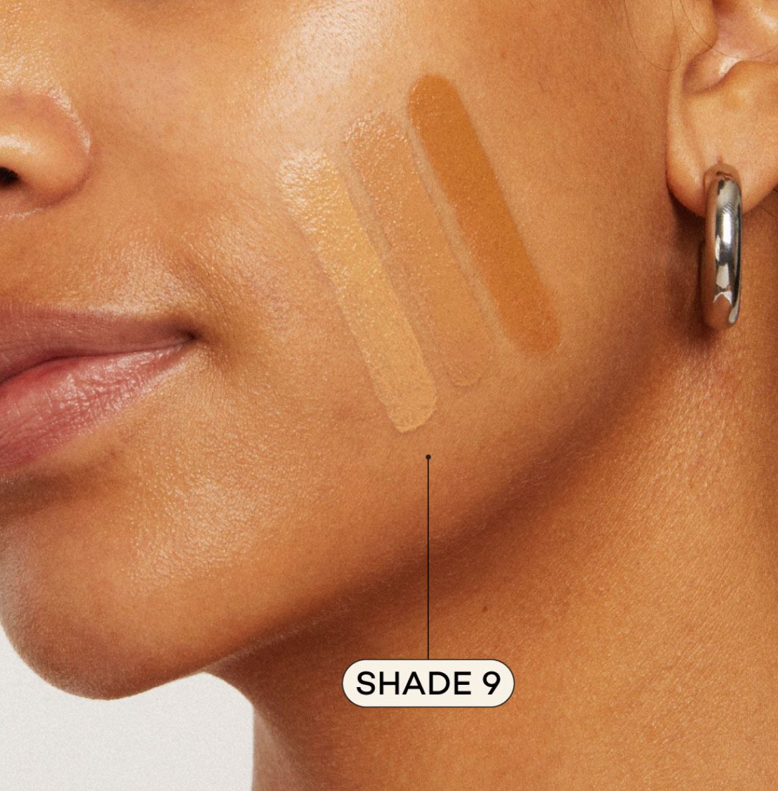 Medium skinned woman featuring medium foundation swatched on cheek