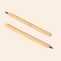 Two Bamboo Switch Bamboo Alloy Pencils with sharpened tips lie diagonally on a light beige background, reflecting the simplicity and reliability of a no-smudge pencil.