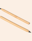 Two Bamboo Switch Bamboo Alloy Pencils with sharpened tips lie diagonally on a light beige background, reflecting the simplicity and reliability of a no-smudge pencil.
