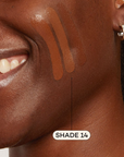 Dark skinned woman featuring Dark foundation swatched on cheek