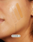 Medium skinned woman featuring medium foundation swatched on cheek