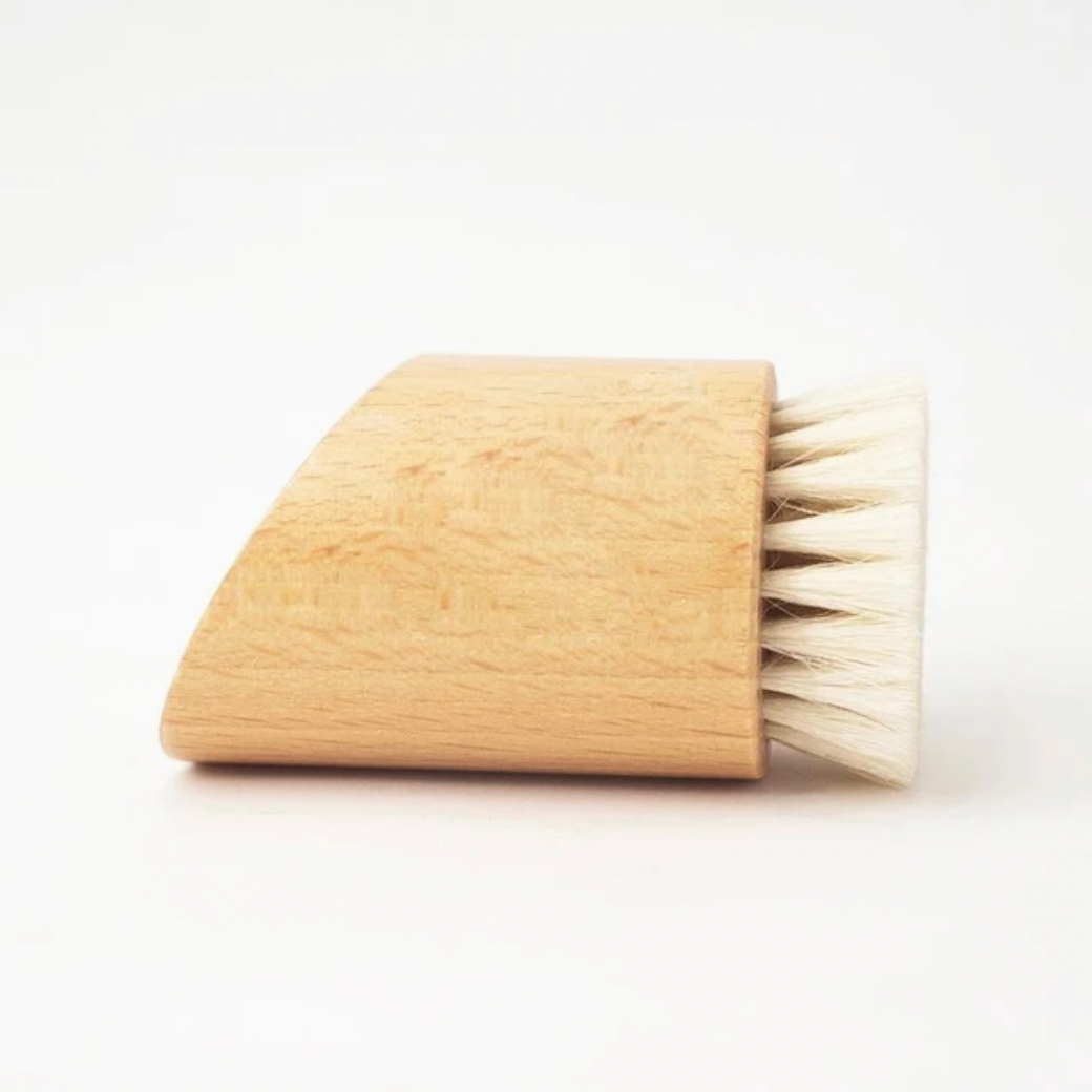 Angular wood shaving brush on white background