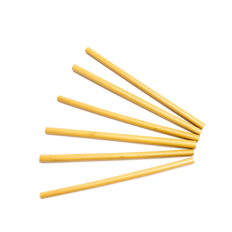An array of reusable and compostable bamboo straws on a white background. 