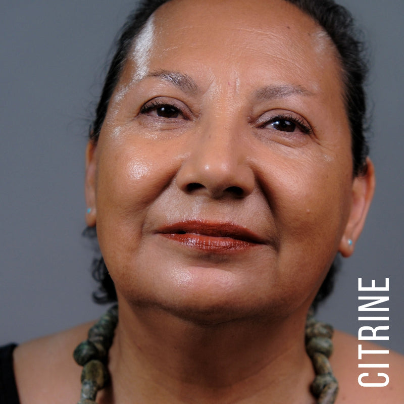 A model wearing the skin tint in the shade Citrine. 