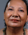 A model wearing the skin tint in the shade Citrine. 