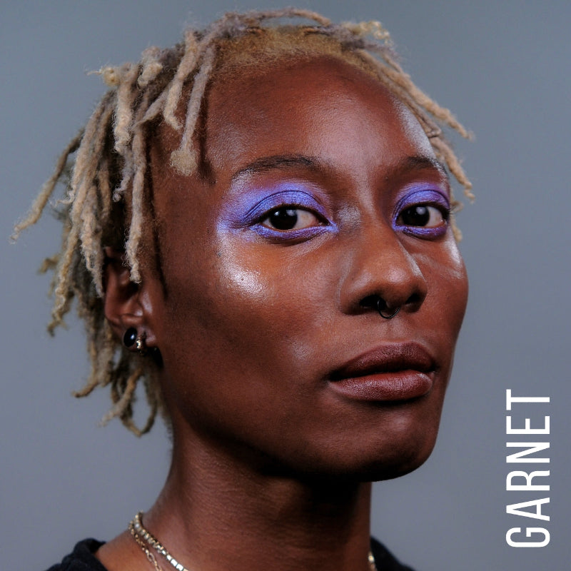 A model wearing the skin tint in the shade Garnet. 