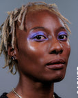 A model wearing the skin tint in the shade Garnet. 