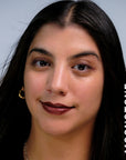 A model wearing the skin tint in the shade Moonstone. 