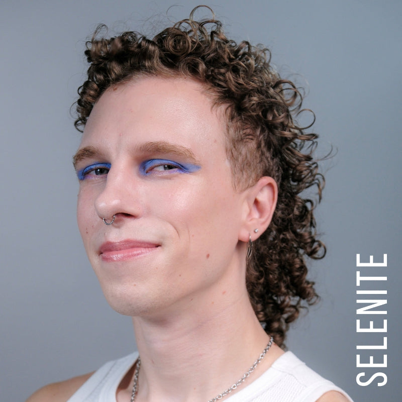 A model wearing the skin tint in the shade selenite. 