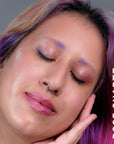 A model wearing the skin tint in the shade Rose Quartz