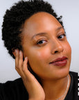 A model wearing the skin tint in the shade topaz.
