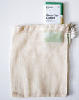 Mesh bag with a green tea crunch product on a white background