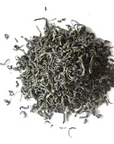 A close up on a pile of loose Spring Green Tea on a white background. 