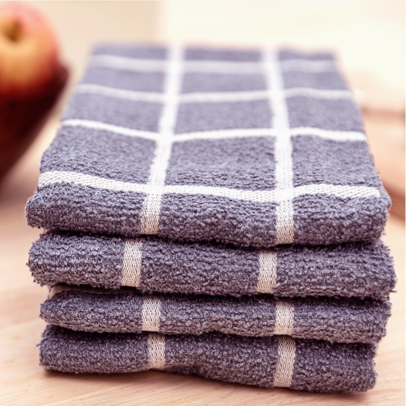 Stack of purple checkered towels on a wooden surface
