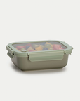 Rectangular food storage container with a transparent lid on a light gray background