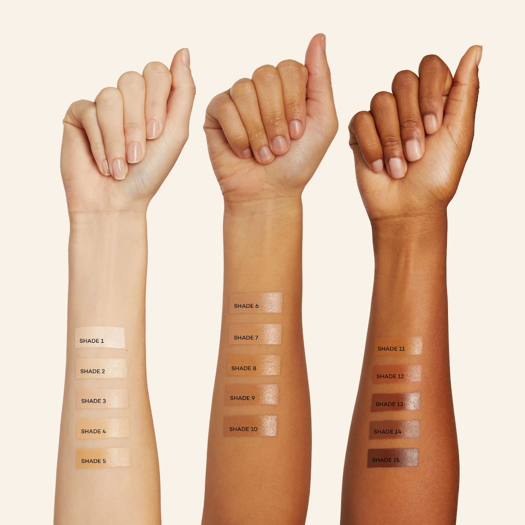 light medium and dark skinned arms with makeup foundation swatched on them on white background.