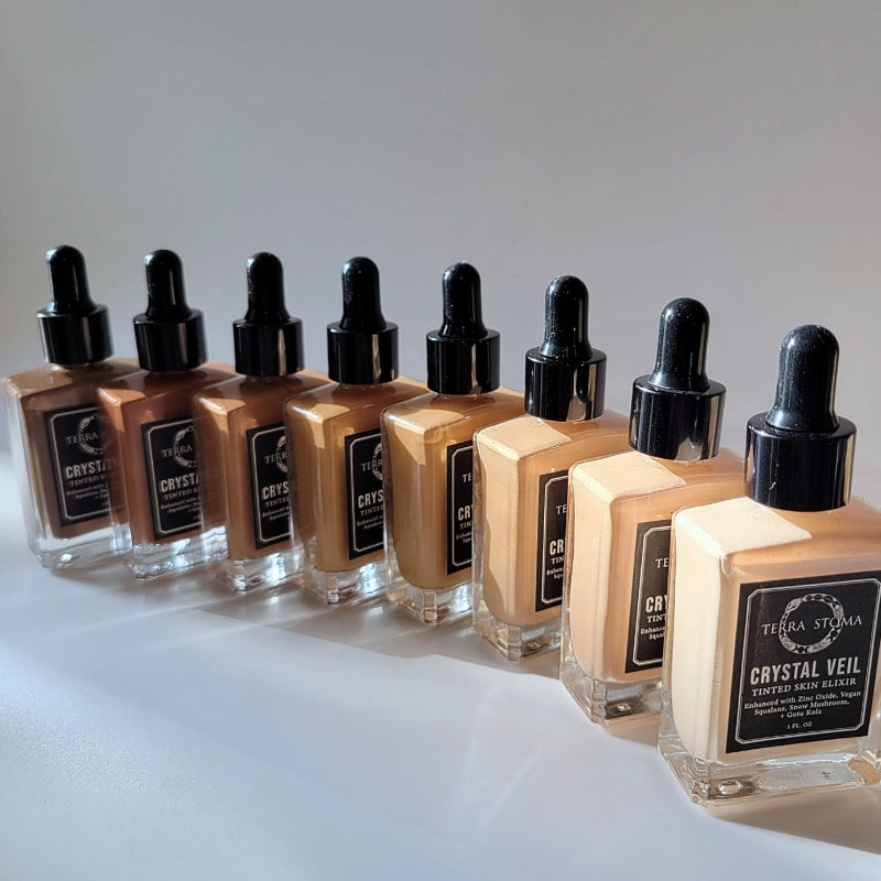 Every shade of the Terra Stoma Skin Elixir in row on a white background. 
