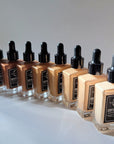 Every shade of the Terra Stoma Skin Elixir in row on a white background. 